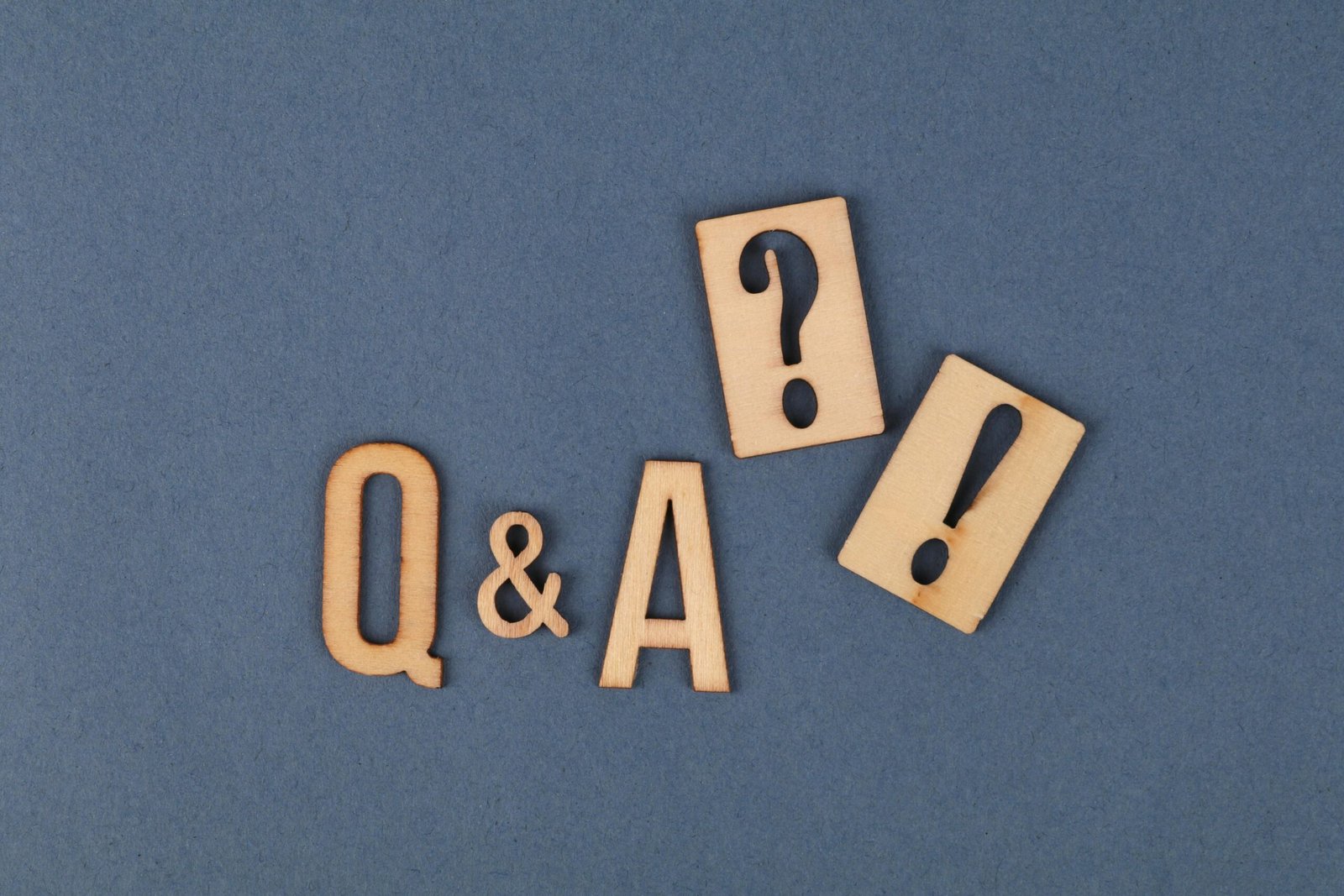 Flat lay of wooden Q&A letters from our virtual assistants